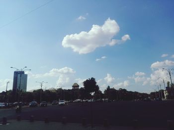 City street by buildings against sky