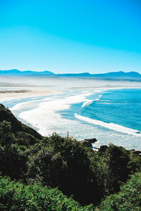 Scenic view of sea against clear blue sky