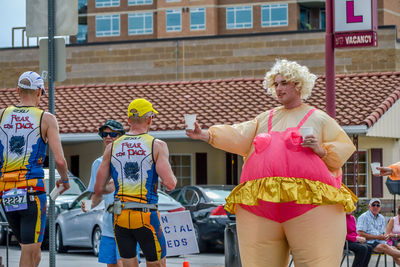 Full length of men standing on street in city