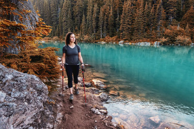 Full length of man standing on rock in forest