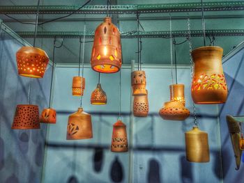 Low angle view of illuminated lights hanging on ceiling