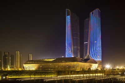 Illuminated modern buildings in city at night