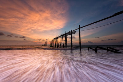 Silhouette pier on sea against sky during sunset