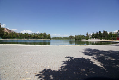 Scenic view of lake against clear blue sky