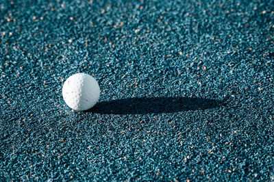 Close-up of golf ball on ground