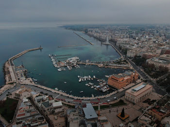 High angle view of townscape by sea against sky