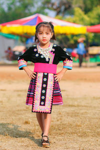 Portrait of a girl standing on field