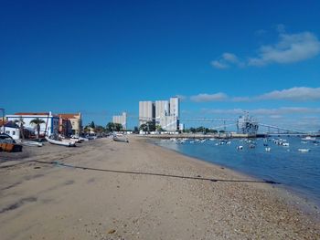 City by sea against blue sky