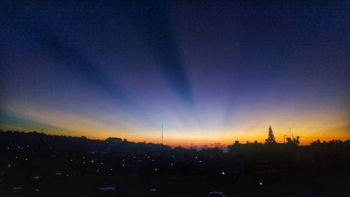 Silhouette buildings against sky during sunset