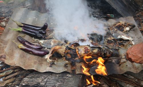 High angle view of person preparing food over fire