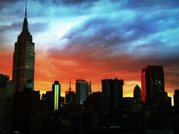 Skyscrapers in city at dusk