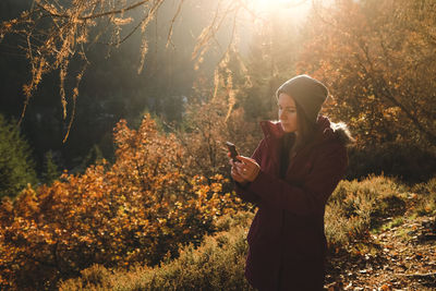 Woman using phone outdoors