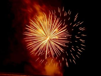 Low angle view of firework display at night