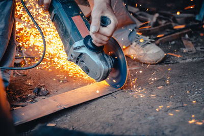 Close-up of man grinding metal 