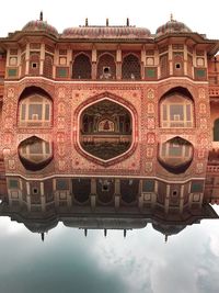 Low angle view of building against cloudy sky