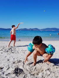 Full length of boys on beach