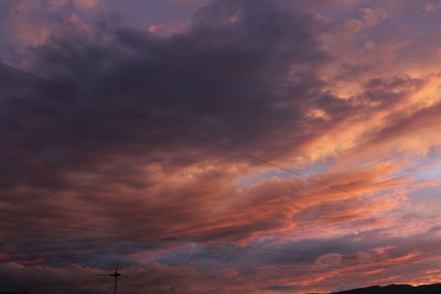 Low angle view of cloudy sky at sunset