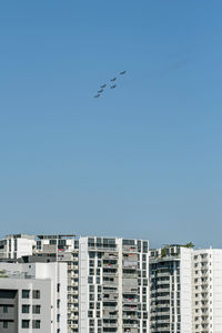 Low angle view of buildings against clear blue sky