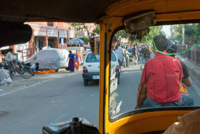 Rear view of man sitting on street