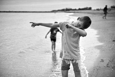 Full length of boy on sea shore