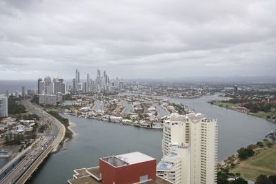 High angle view of buildings against cloudy sky