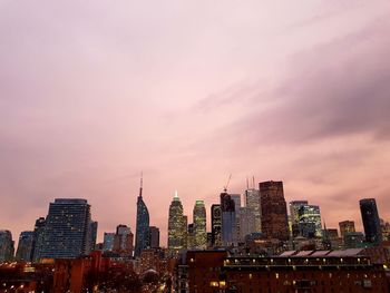 View of skyscrapers against cloudy sky