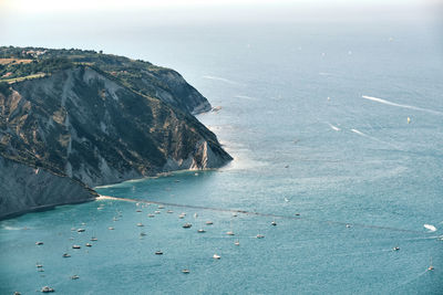 Scenic view of sea and mountains against sky