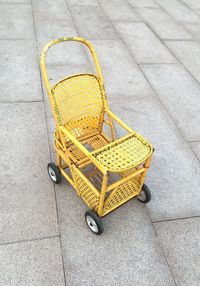 High angle view of yellow stroller on street