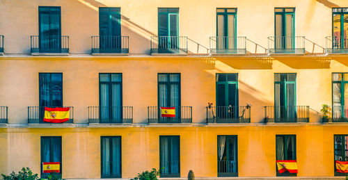 Facade with windows and spanish flags.
