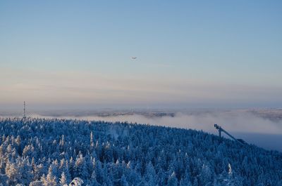 Scenic view of snow covered land against sky during sunset