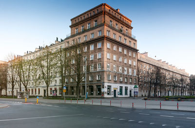 Road by building against sky