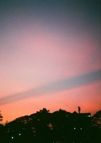 Silhouette trees against sky during sunset