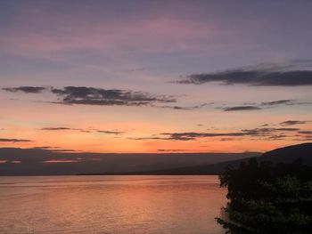 Scenic view of sea against romantic sky at sunset