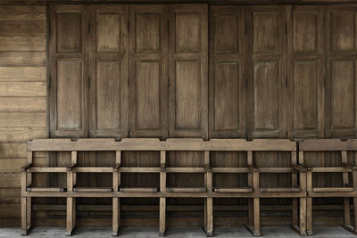 Wooden chairs against wall