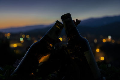 Close-up of alcohol bottles at night