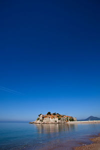 Scenic view of sea against clear blue sky
