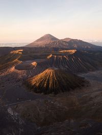 Aerial view of volcanic landscape against sky during sunset