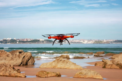 Quadrocopter flying on the beach
