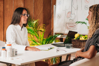 Female nutritionist advising a client in weight loss clinic