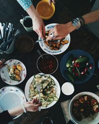 High angle view of people serving themselves food on a table