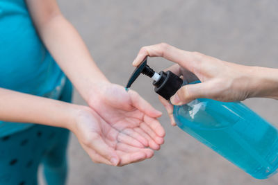 Close-up of woman hand holding bottle