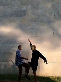 Man and woman standing on field against sky