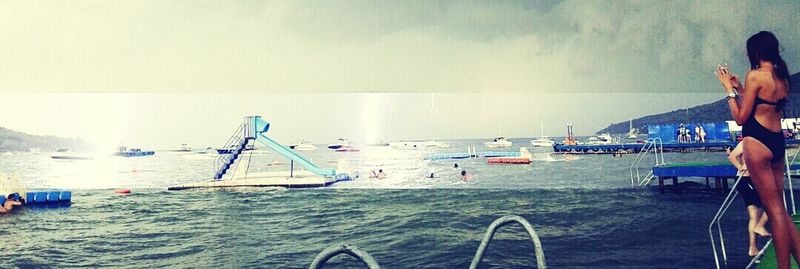 People on beach against sky