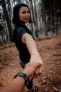 Portrait of beautiful woman lying on land