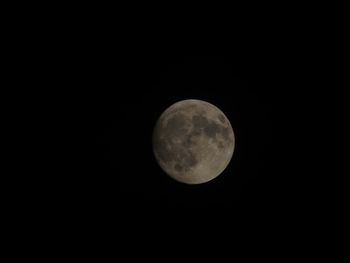 Low angle view of moon against dark sky