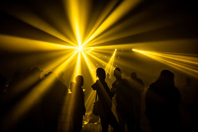 Silhouette people enjoying music concert / festival at night