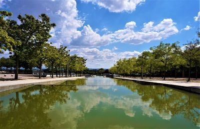 Scenic view of swimming pool by lake against sky