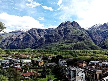 Townscape by mountains against sky