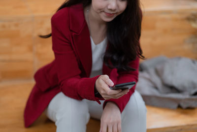 Midsection of woman using mobile phone