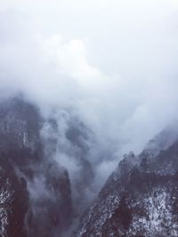 Scenic view of mountains against cloudy sky